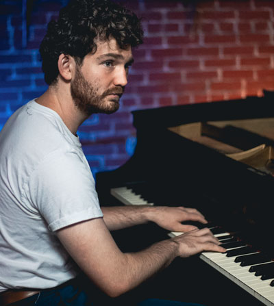 Cameron Riggs, pianist, sits at piano