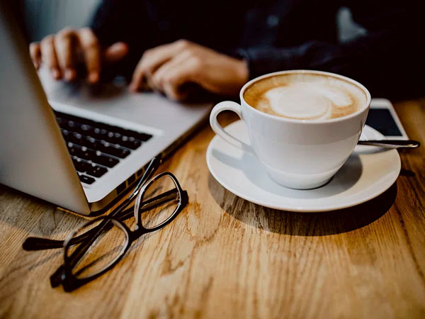 Office photo of laptop and coffee cup